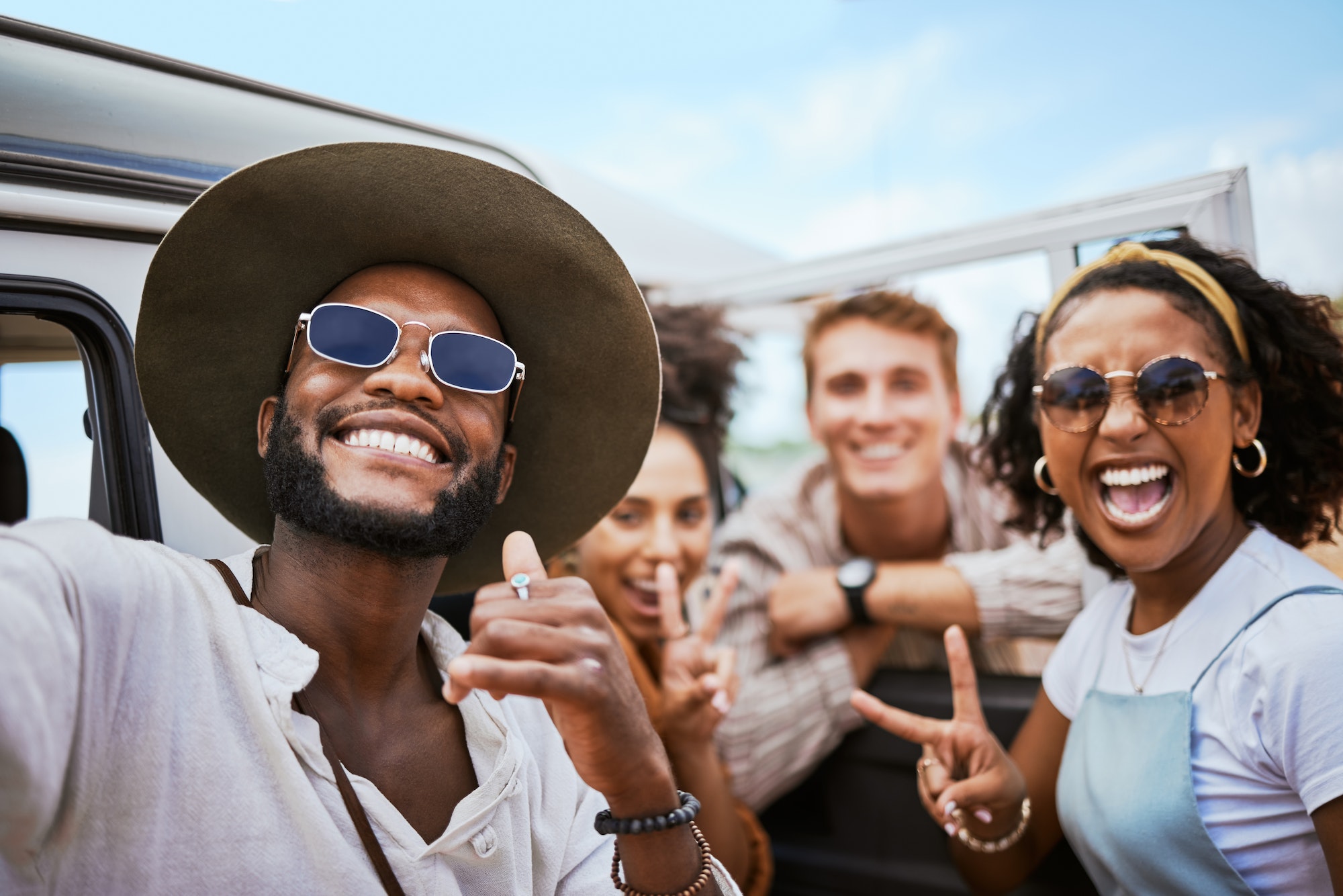 Travel, adventure and selfie with friends celebrating freedom and showing hand peace sign outdoors.